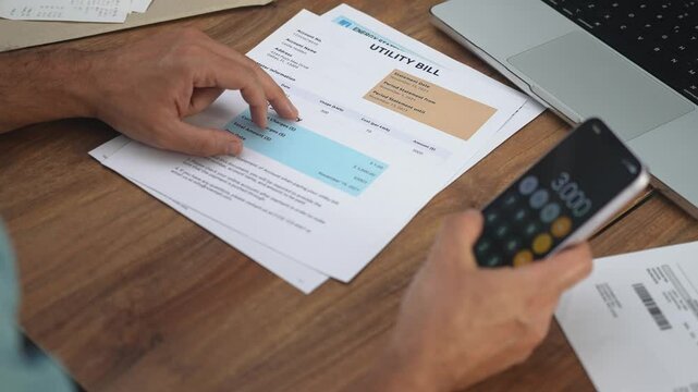 Elderly male office worker holds bills in hands counting amount of utilities together, man accountant makes report about household expenses of company slow motion