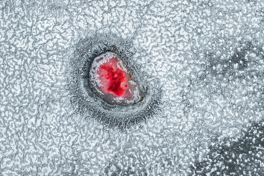 Drone view of a vibrant red salt pond in La Puna