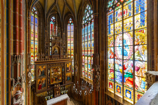 Impressive stained glass windows illuminating gothic church interior in Spissky Stvrtok, Slovakia
