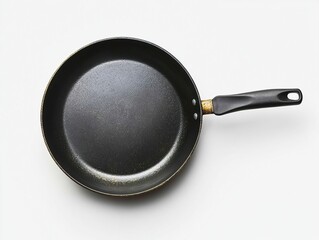 Well-used non-stick frying pan with black handle, top down view on a white surface, simple kitchen tool.