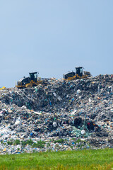 Landfill compactors working on a huge pile of garbage in Slovakia
