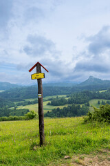 Hiking trail sign pointing towards scenic landscape in Slovakia