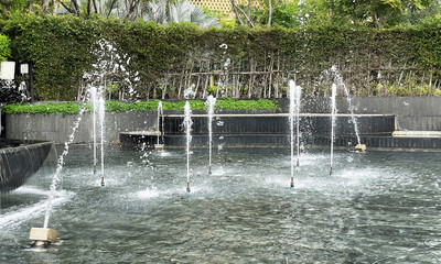 Fountain dancing on public park show bubbles of water coming out of the water nozzle.