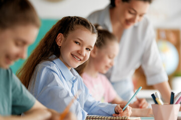 Happy kids and teacher at school