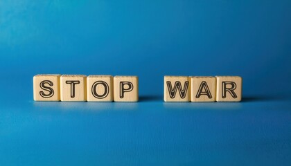 wooden letter blocks spelling stop war on a blue background, symbolizing peace and anti war message, perfect for advocacy or awareness campaigns
