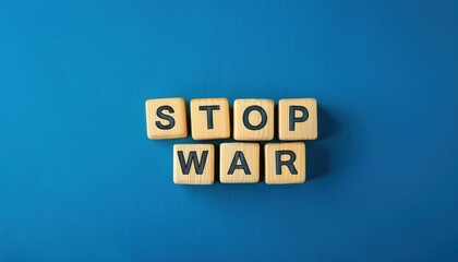 wooden letter blocks spelling stop war on a blue background, symbolizing peace and anti war message, perfect for advocacy or awareness campaigns