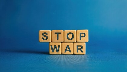 wooden letter blocks spelling stop war on a blue background, symbolizing peace and anti war message, perfect for advocacy or awareness campaigns