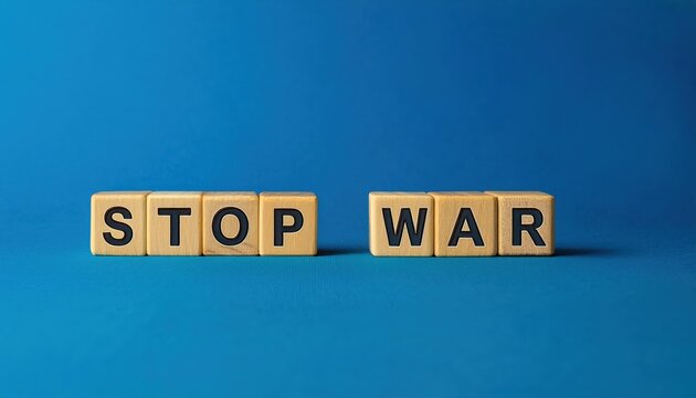 Naklejki wooden letter blocks spelling stop war on a blue background, symbolizing peace and anti war message, perfect for advocacy or awareness campaigns