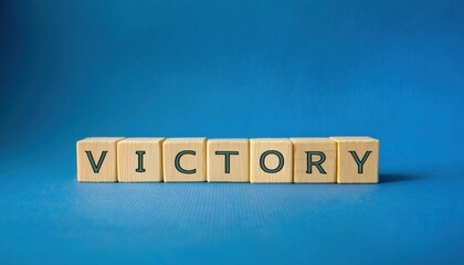 wooden letter blocks spelling victory against a blue background with bold typography, ideal for motivational branding or success themed content