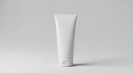 Blank white cosmetic tube standing upright on a light grey background