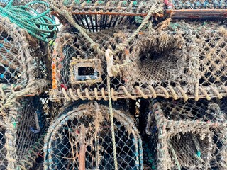 Close up of stacked used lobster pots coated with seaweed