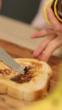 Spreading Vegemite on Toast in a Kitchen Setting