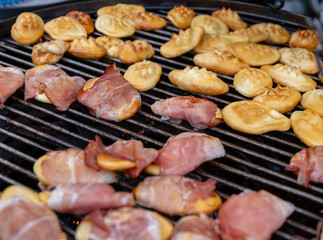 Traditional Polish street food, Oscypek - smoked sheep cheese on a grill, sold at the Christmas market