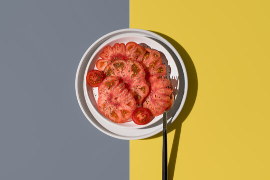 Top view of raf tomato with spices on a plate