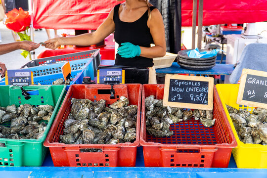 Woman at an oyster stand in Arcachon Bay market