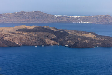 View from Santorini to volcanic island Nea Kamena, Cyclades, Greece