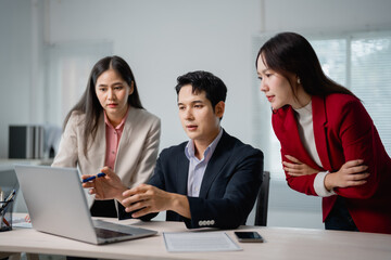 Business team collaborating on a project in a modern office, utilizing a laptop to discuss and share innovative ideas for their upcoming business strategy and planning