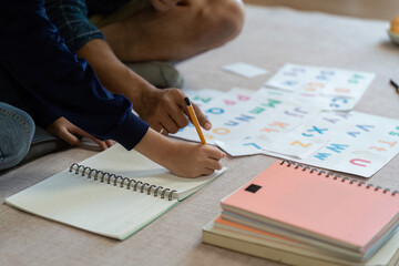 Naklejka premium Father and Son Learning Together. Engaging in educational activities at home.