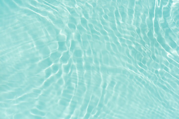 Blue water with ripples on the surface. Defocus blurred transparent blue colored clear calm water...