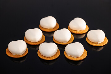 Lavender mousse cakes isolated on black background. Vanilla sable, lemon curd, blueberry custard, lime mousse. Tasty sweet dessert. Ideal for gourmet dessert lovers