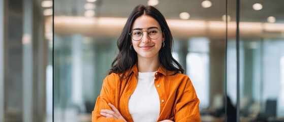 The confident woman smiling in a modern office environment with stylish attire.
