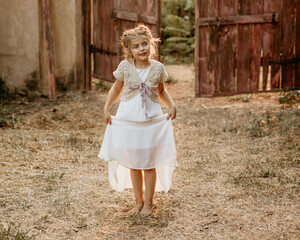 Beautiful girl with pigtails in the village in summer