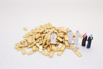 Group of Figurines Standing Beside a Pile of Gold Bars