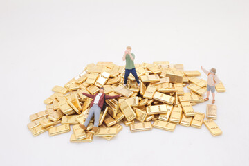 Miniature Figurines Exploring a Gold Bar Treasure Surrounded by Wealth