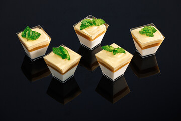 Sweet delicious dessert decorated with whipped cream topping. Five small glasses with chocolate...