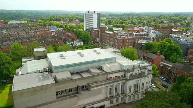 Overhead reversing aerial video of Ulster Museum in Botanic Gardens in Belfast, Northern Ireland on a bright sunny day. Produced in 4K, 60 frames per second and with Rec709 color.