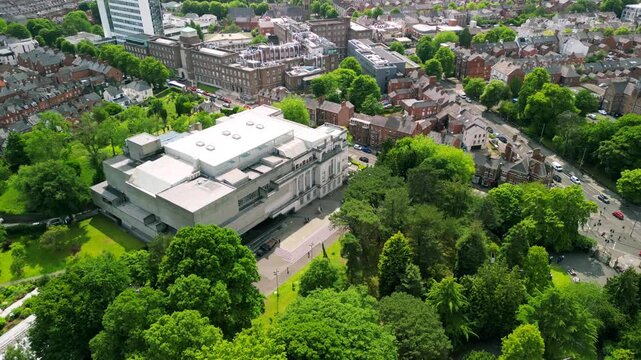 Anti-clockwise travelling aerial video of Ulster Museum in Botanic Gardens in Belfast, Northern Ireland on a bright sunny day. Produced in 4K, 30 frames per second and with Rec709 color.