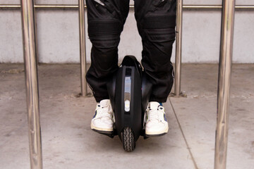 Individual riding a unicycle in a modern urban environment during daylight
