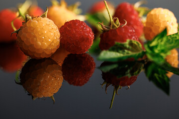 Raspberry with leaves. Fresh red ripe raspberries. Delicious fresh raspberries isolated on black...
