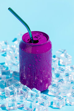 Refreshing purple soda with straw and ice cubes