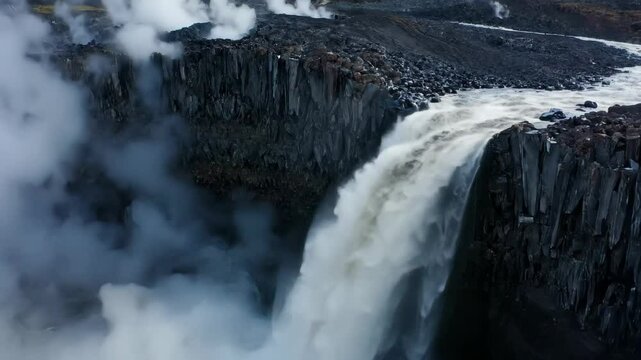 Dramatic Iceland Style Waterfall with Steam, Aerial Drone Video of Massive River