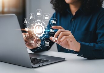 Woman using laptop with logistics icons hovering above screen