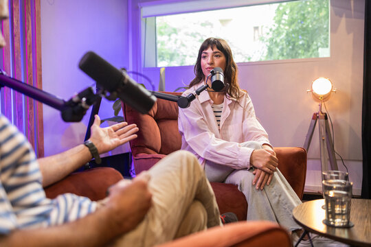 Modern podcast conversation in cozy studio setting