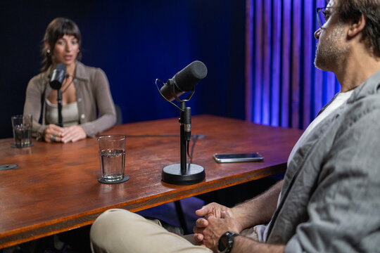 Woman and man in engaging podcast interview session