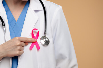 Doctor Highlighting Breast Cancer Awareness with Pink Ribbon