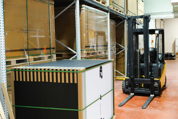 Solar panel storage in a warehouse with a forklift