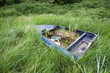 Abandoned vessel – a lonely boat marooned in a desolate tidal estuary. The image evokes themes of...