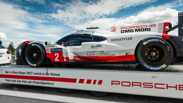 Porsche racecar being transported on a trailer. Le Mans winning sports prototype car being towed around public roads as publicity stunt. Germany - July 08 2017