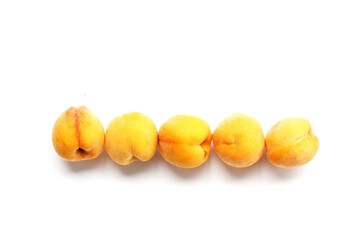 Fresh ripe apricots on a white background.