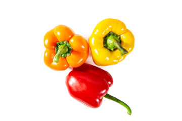 Fresh juicy shiny red, yellow and orange bell peppers. Isolated on white.