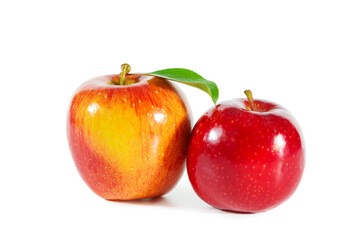 Shiny juicy red apples with leaves isolated on white background.