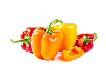 Mix of colorful whole and sliced ​​bell peppers. Isolated on white background.