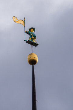 Close-up view of the golden Old Thomas weather vane on the spire of Tallinn Town Hall, a historic landmark and iconic medieval symbol of the city.