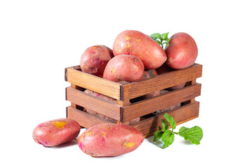 Red potatoes in a wooden box isolated on white background.