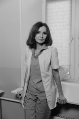 Beautiful Caucasian female doctor with short dark hair and white skin in a medical office