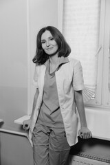 Beautiful Caucasian female doctor with short dark hair and white skin in a medical office